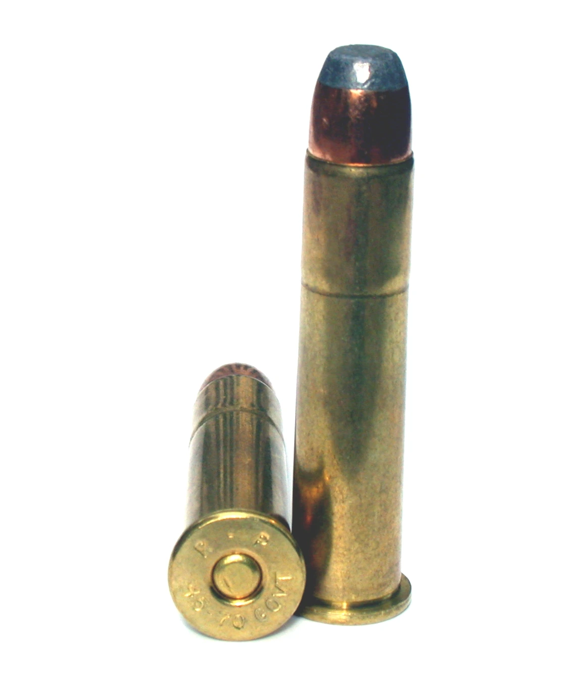 Two .45-70 cartridges on a white ground. One stands upright, a tall straight brass case with a broad flat-nosed bullet whose grey lead tip sits in a copper jacket. The second lies on its side in front, showing a wide flanged rim and a headstamp reading “R-P 45-70 GOVT”.