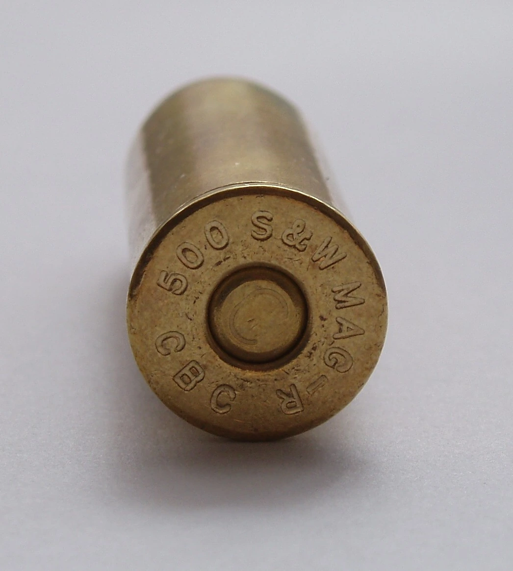 The base of a brass cartridge seen end-on, showing a central primer and the stamped lettering "500 S&W MAG" and "CBC" around it.