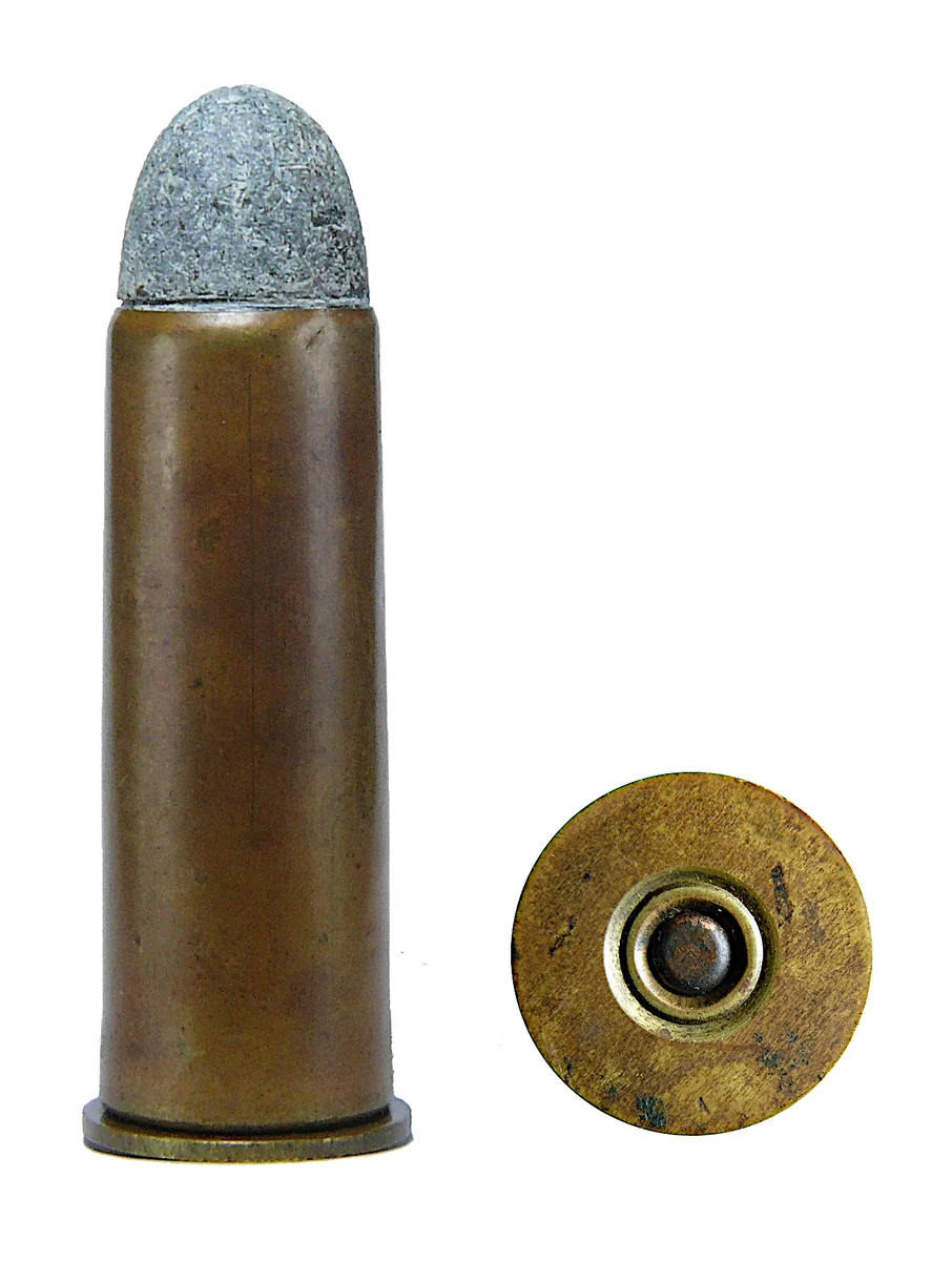 A .577 Snider cartridge with a plain drawn brass case, beside its own base