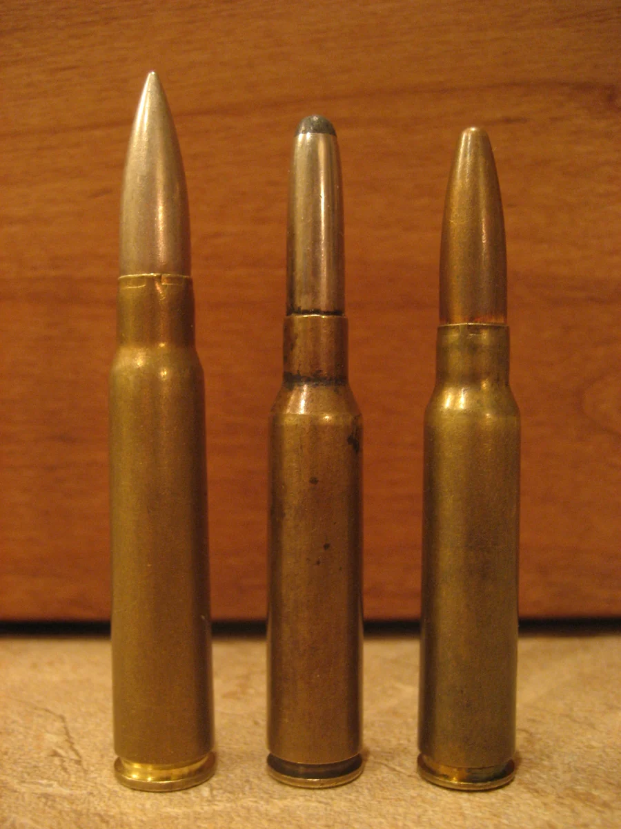 Three brass rifle cartridges of decreasing size standing side by side