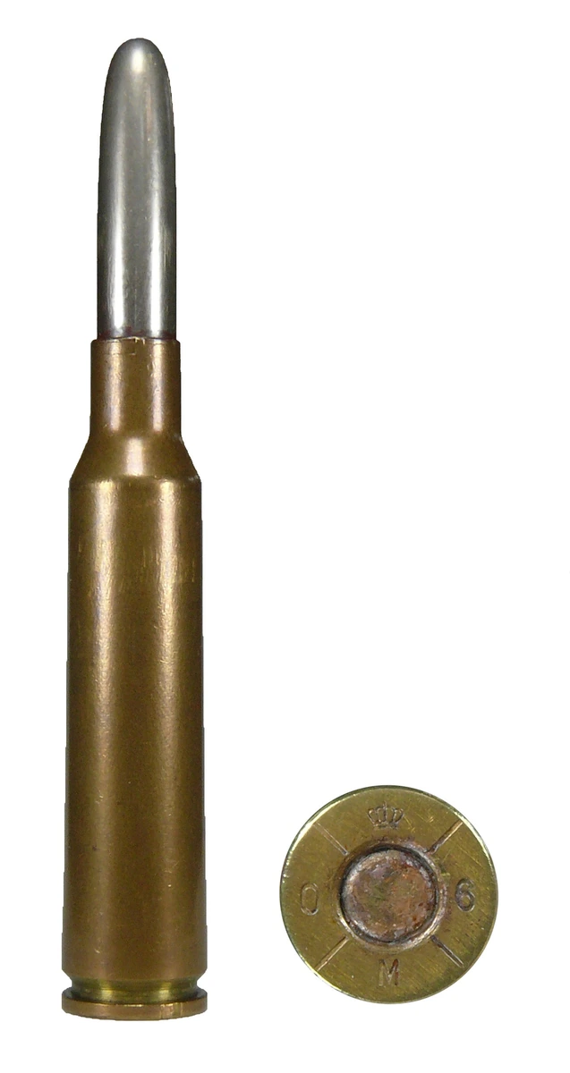 A 6.5x55mm military ball cartridge with a silvery round-nosed bullet in a copper-washed case, photographed beside a second view of the same case head. The headstamp is quartered by four segments and marked with a crown, the letters O and M, and the figure 6.
