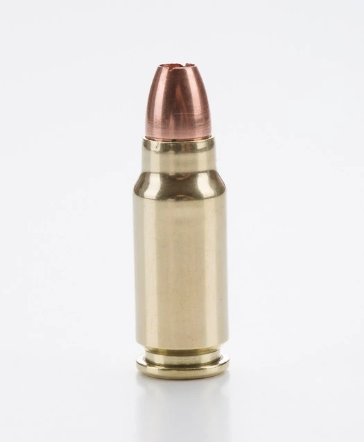 A brass bottleneck pistol cartridge with a rounded copper jacketed bullet, standing upright