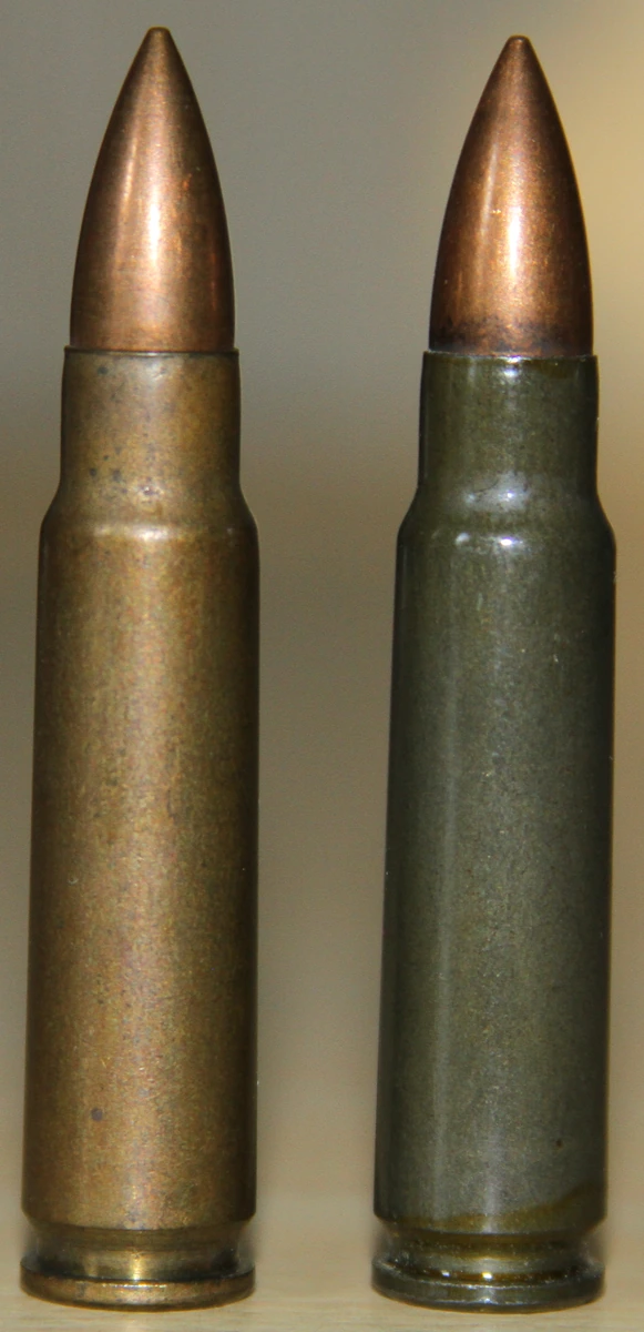 Two 7.62x45mm cartridge cases side by side, one brass-coloured and one dark grey