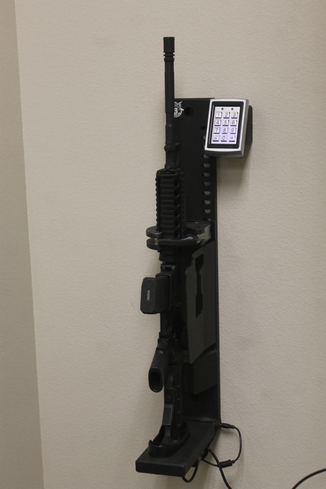 An AR-15 type rifle held in a vertical wall mount