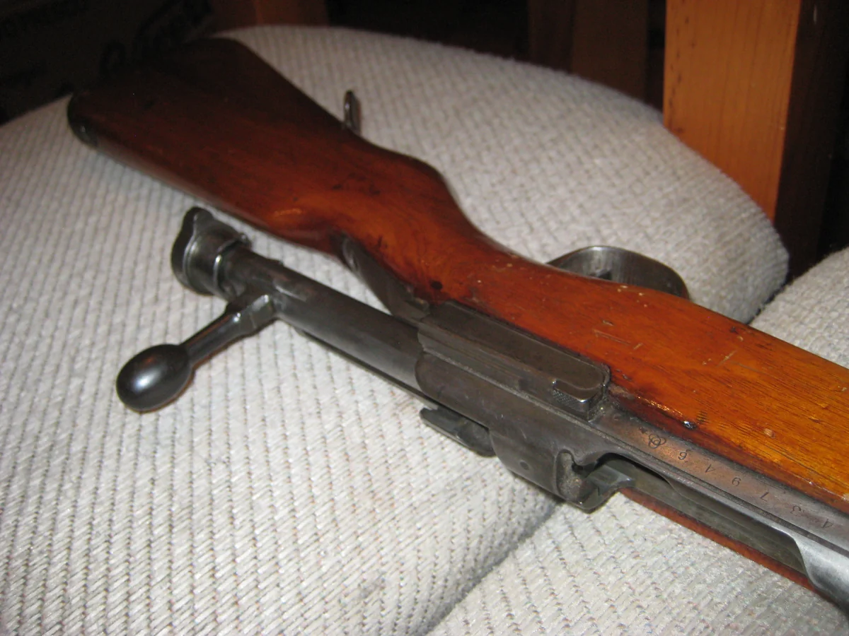 Close-up of an Arisaka bolt-action rifle's turned-down bolt handle and receiver