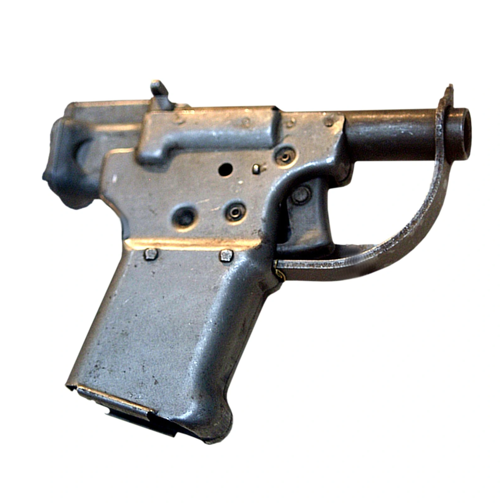 A crude, blocky pistol with a rectangular stamped-steel body, a bent-wire trigger guard and a short barrel, photographed against a plain white background