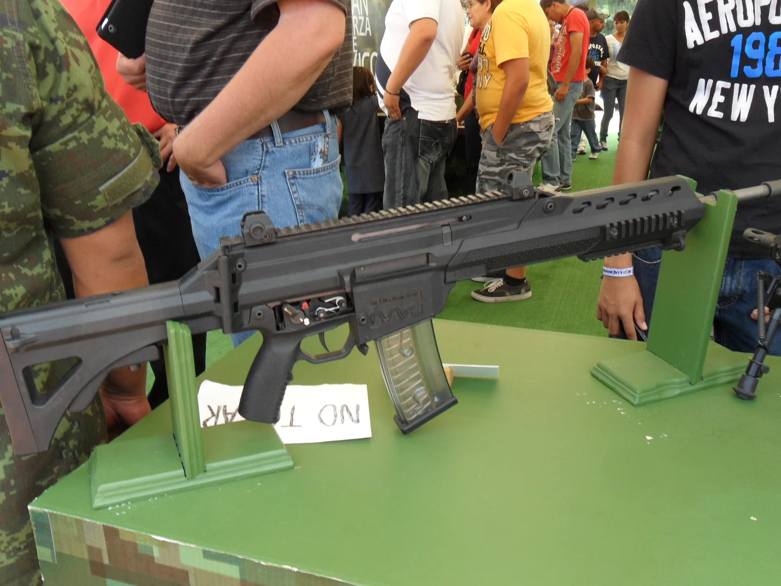 An FX-05 rifle with folding stock and Picatinny rail, laid on a display table at an arms exhibition