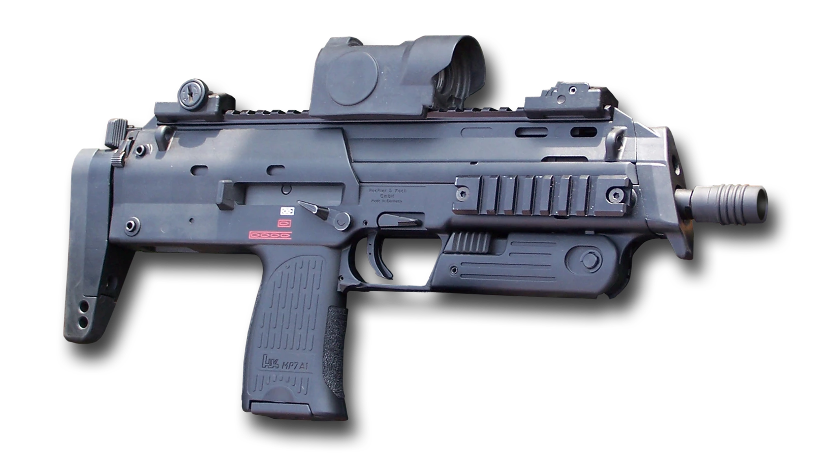 An MP7A1 isolated on white, seen from the left, with a folding front grip, a red-dot sight on the top rail, a telescoping stock and a short magazine in the pistol grip