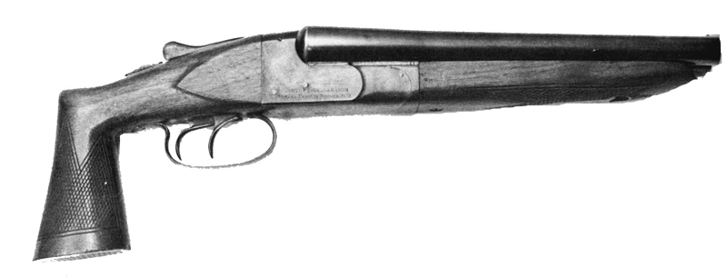 A black-and-white studio photograph of a short double-barrelled shotgun with no shoulder stock: two side-by-side barrels cut to about a foot, a chequered pistol grip and two triggers