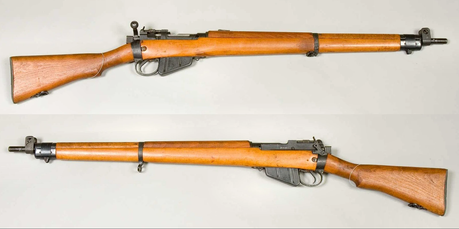 Two views of a Lee–Enfield rifle on a pale background, left and right sides, with a full wooden stock, a bolt handle bent down beside the trigger and a detachable box magazine