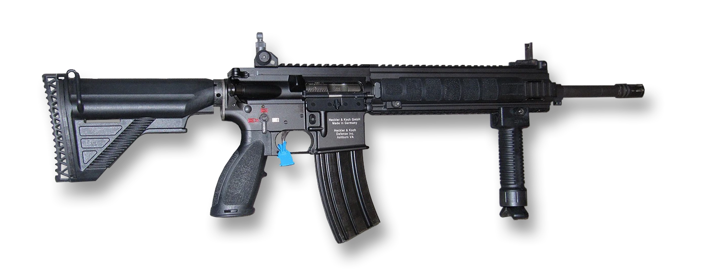 An M27 rifle seen from the left against a plain ground. It has a black telescoping stock, an AR-pattern pistol grip and lower receiver marked Heckler & Koch, a long railed handguard with a vertical foregrip at the front, a folding rear sight on the receiver rail, a curved thirty-round magazine and a flash hider at the muzzle. A blue chamber flag hangs from the ejection port.