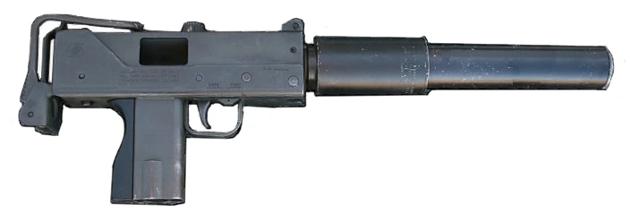 A MAC-10 machine pistol seen from the left, its short boxy receiver ending in a long cylindrical suppressor that is almost as long as the gun itself