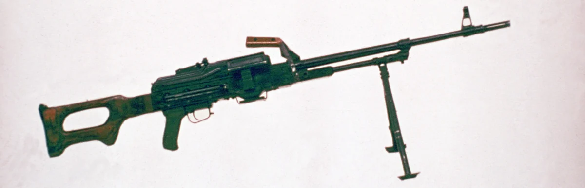 A PKM machine gun photographed from the left side against a plain background