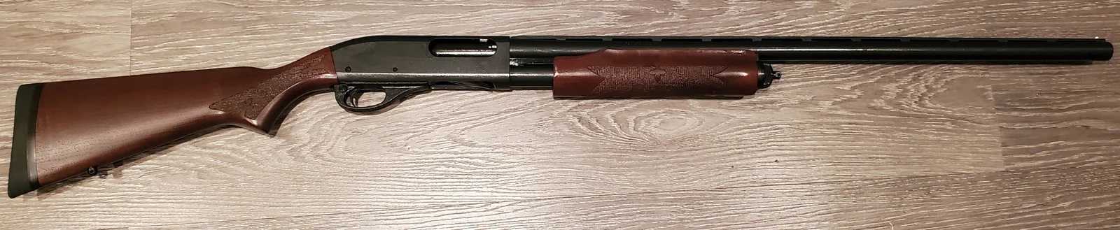 A Remington 870 Fieldmaster pump-action shotgun, right side profile