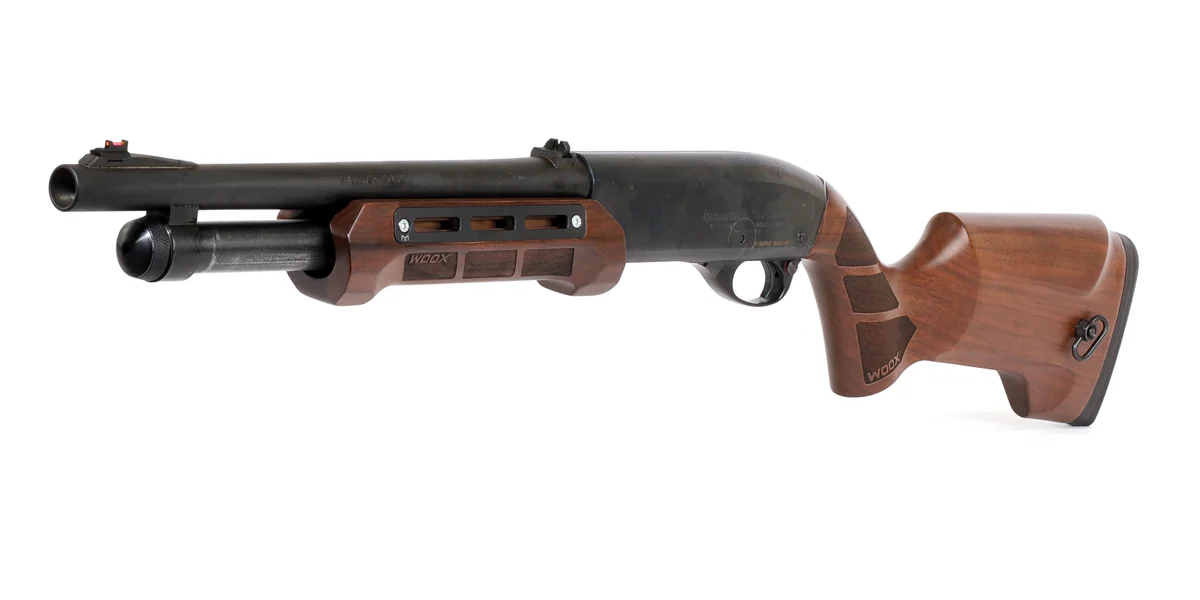 A Remington 870 Wingmaster shotgun with a polished blue receiver and walnut stock