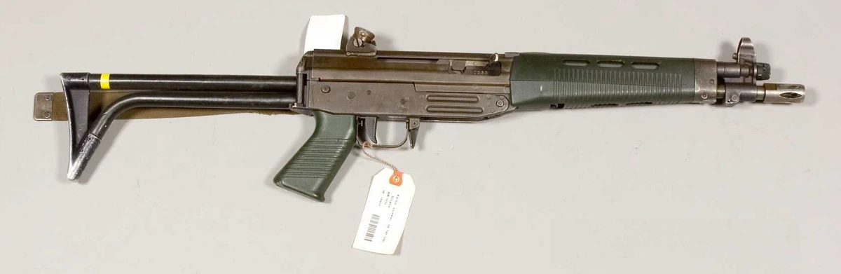A SIG SG 543 carbine with folding stock extended, photographed in profile