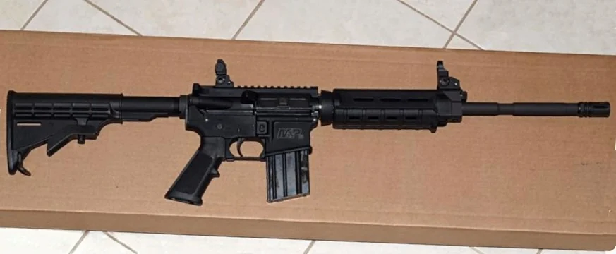 A Smith & Wesson M&P15 Sport rifle, right side profile, isolated on a plain background