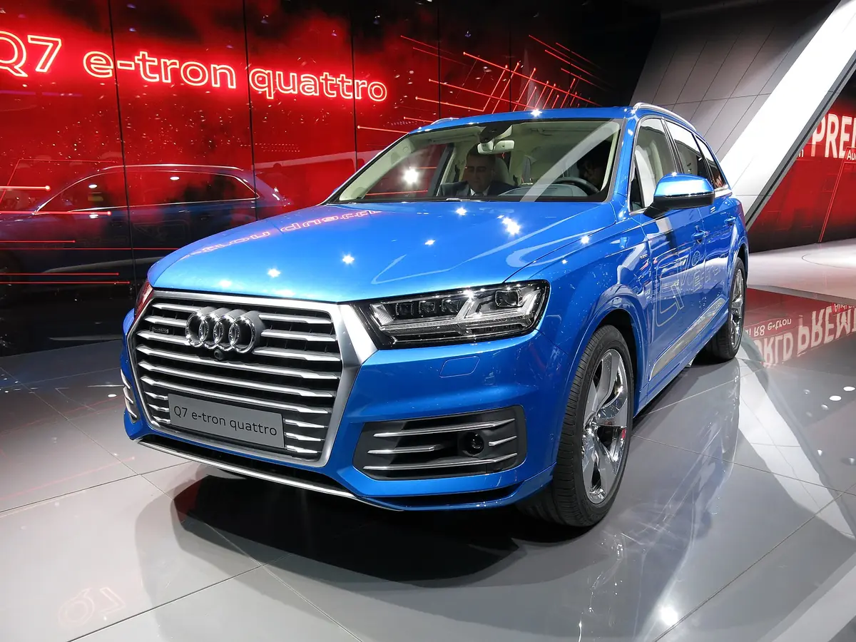 Blue Audi Q7 e-tron plug-in hybrid on a motor show stand