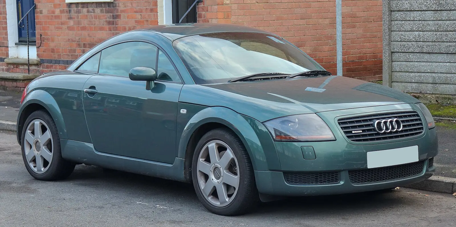 Metallic green first-generation Audi TT quattro coupé photographed from the front three-quarter angle