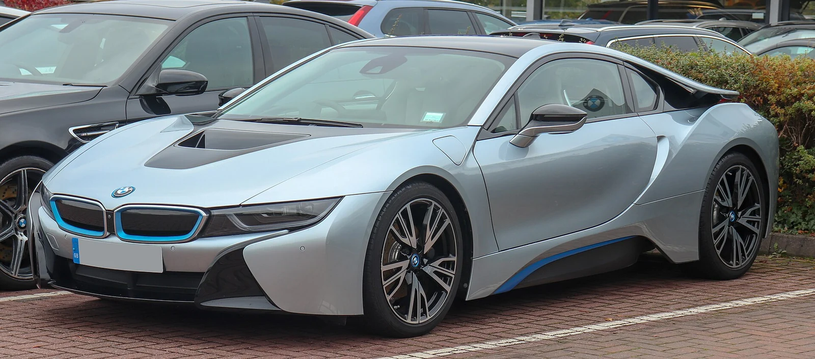 Silver BMW i8 photographed from the front three-quarter angle, showing its low, sculpted body and butterfly doors