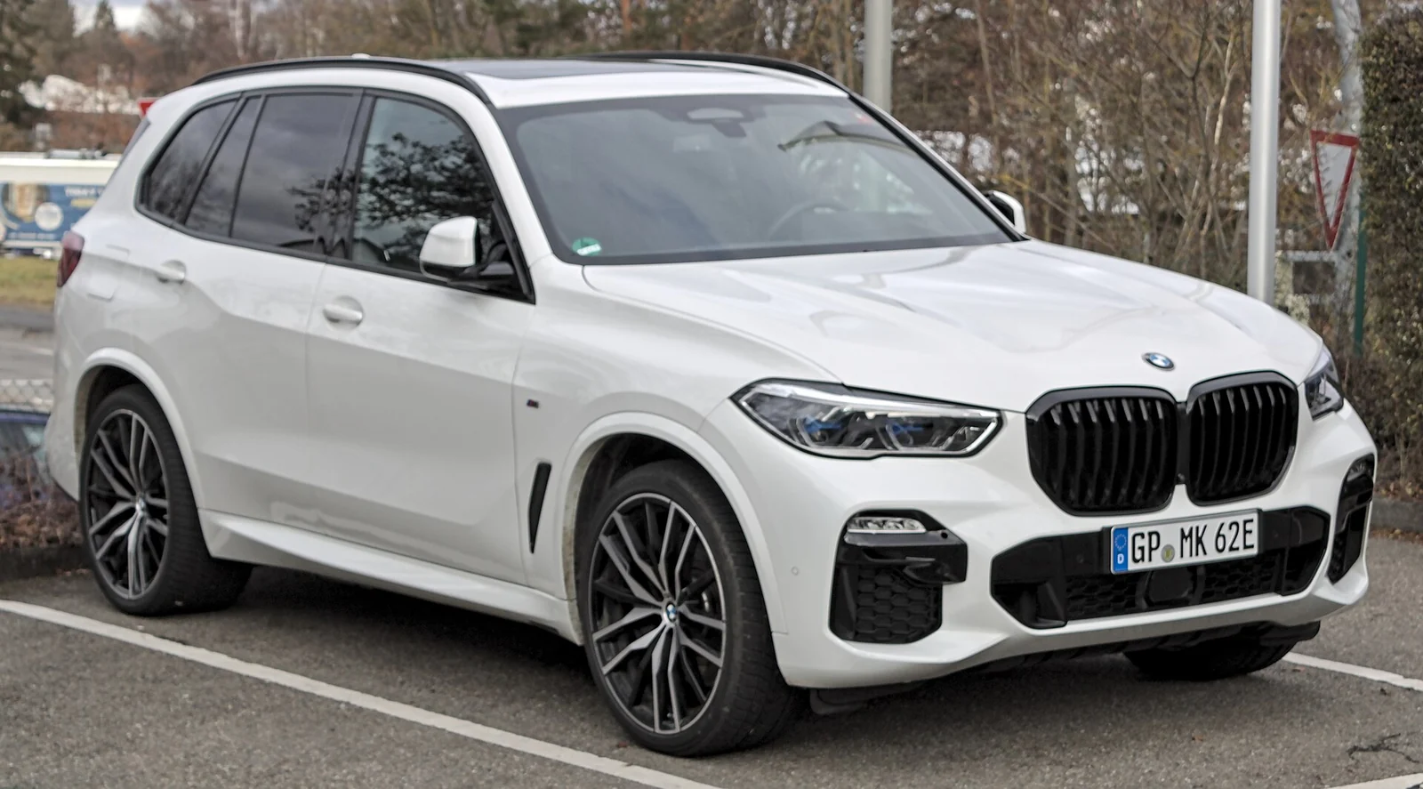 White fourth-generation BMW X5 photographed from the front three-quarter angle, showing its large kidney grille
