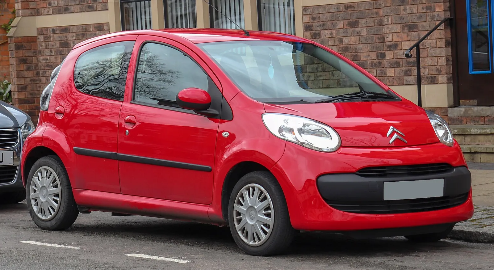Red first-generation Citroën C1 three-door hatchback photographed from the front three-quarter angle