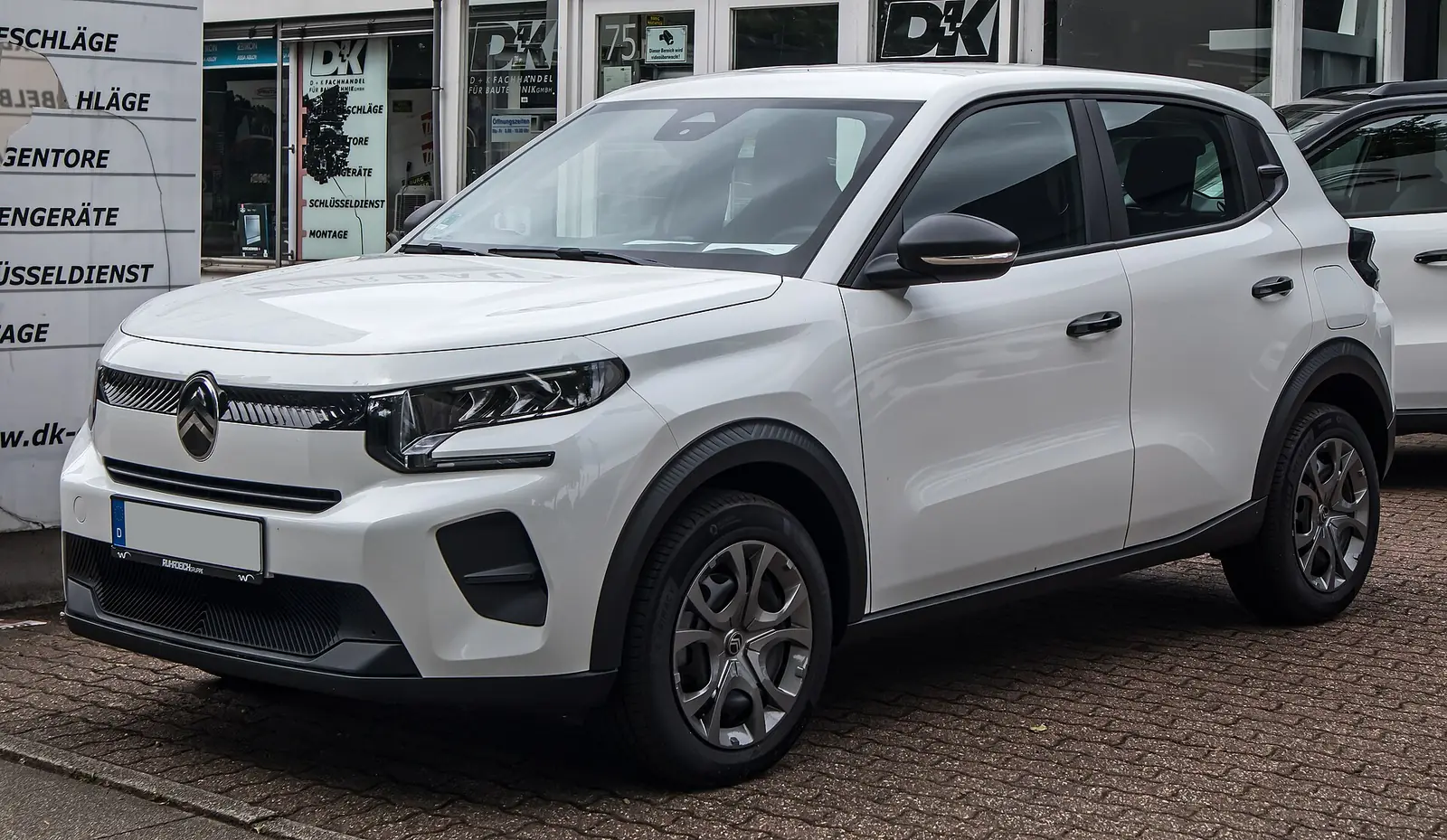 White fourth-generation Citroën C3 hatchback with crossover-styled black cladding, photographed from the front three-quarter angle