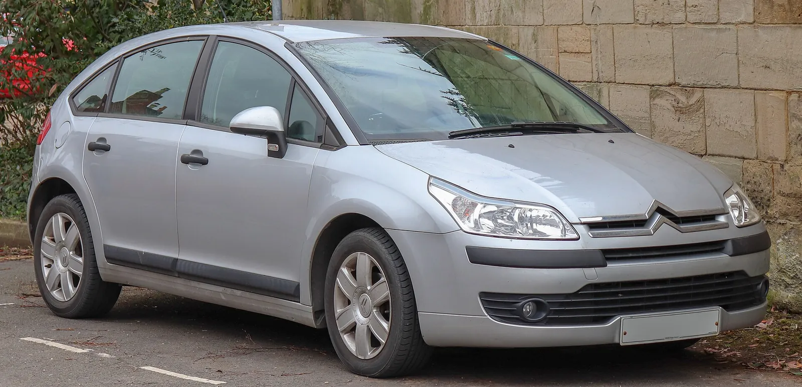 Silver first-generation Citroën C4 five-door hatchback photographed from the front three-quarter angle
