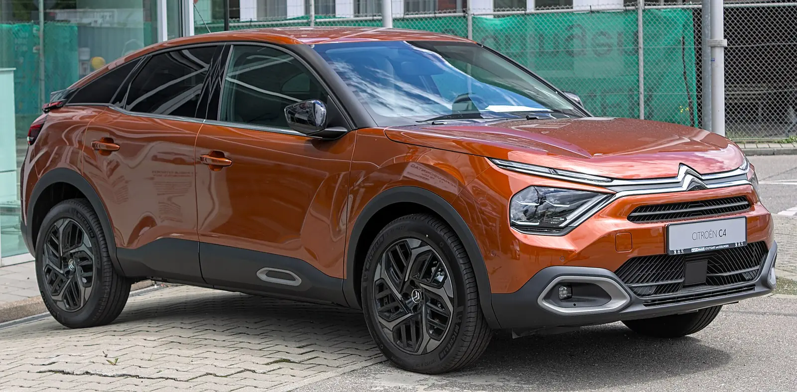 Orange third-generation Citroën C4 crossover hatchback photographed from the front three-quarter angle