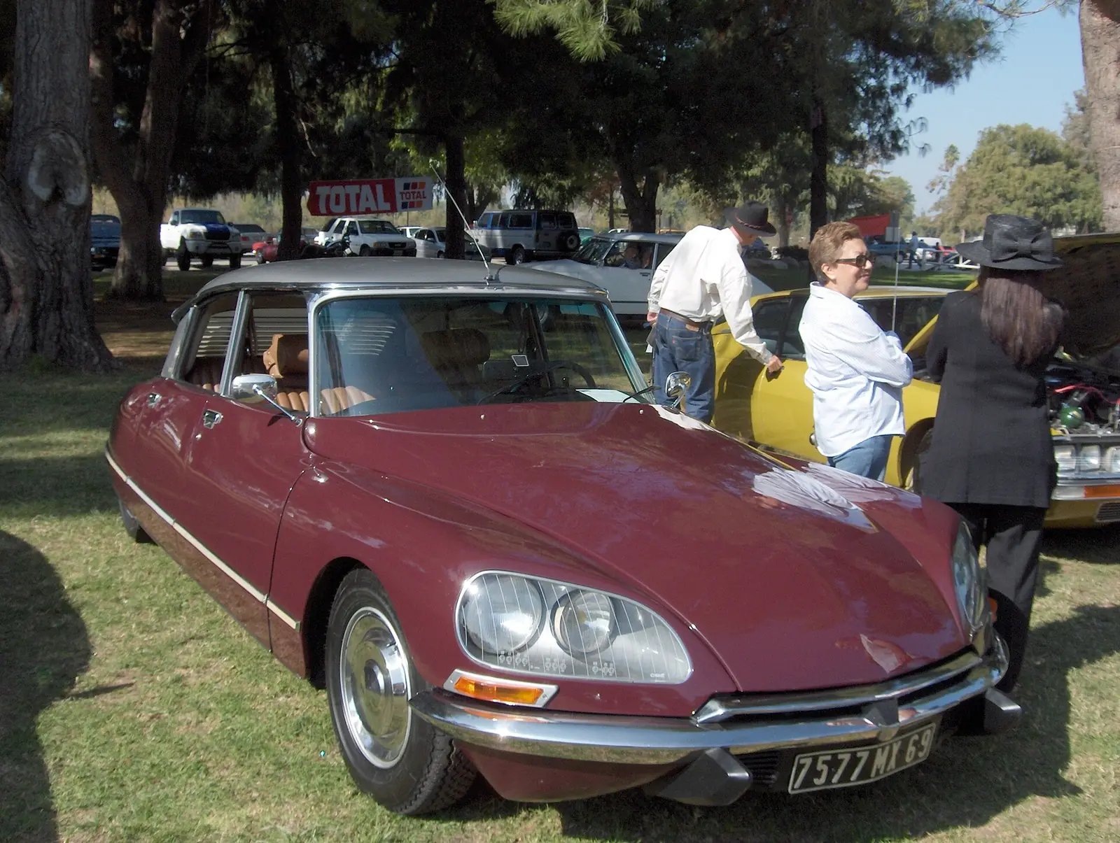 Maroon Citroën DS23 Pallas saloon photographed from the front three-quarter angle, showing its low, sculpted nose and covered rear wheel arches