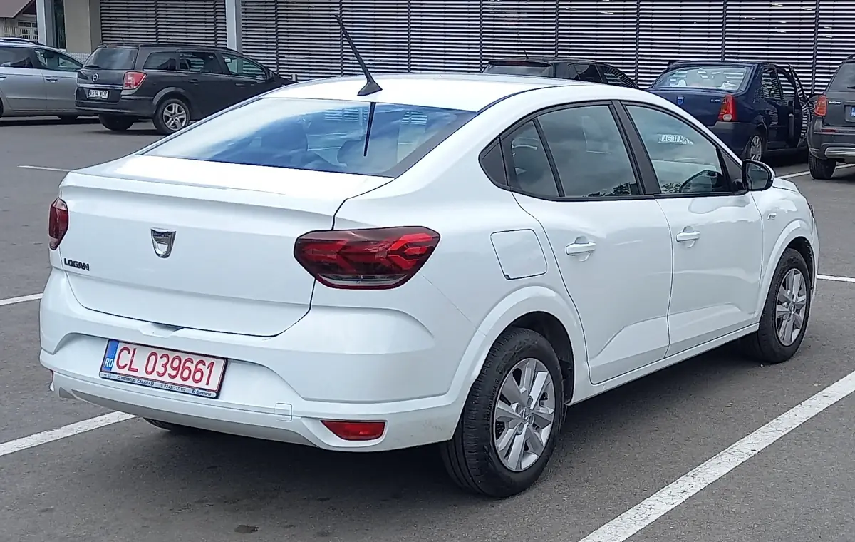 Rear three-quarter view of a white third-generation Dacia Logan saloon