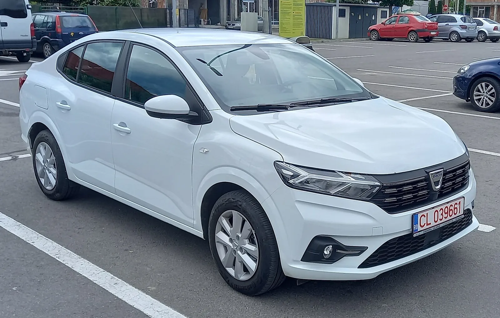 White third-generation Dacia Logan saloon photographed from the front three-quarter angle