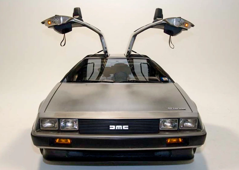 Stainless-steel DeLorean DMC-12 photographed head-on with both gull-wing doors raised