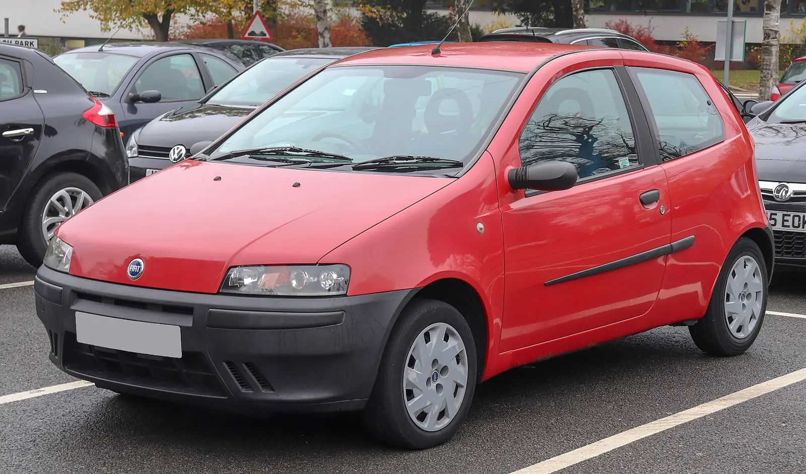 Red second-generation Fiat Punto photographed from the front three-quarter angle, showing its softer, more rounded restyled body