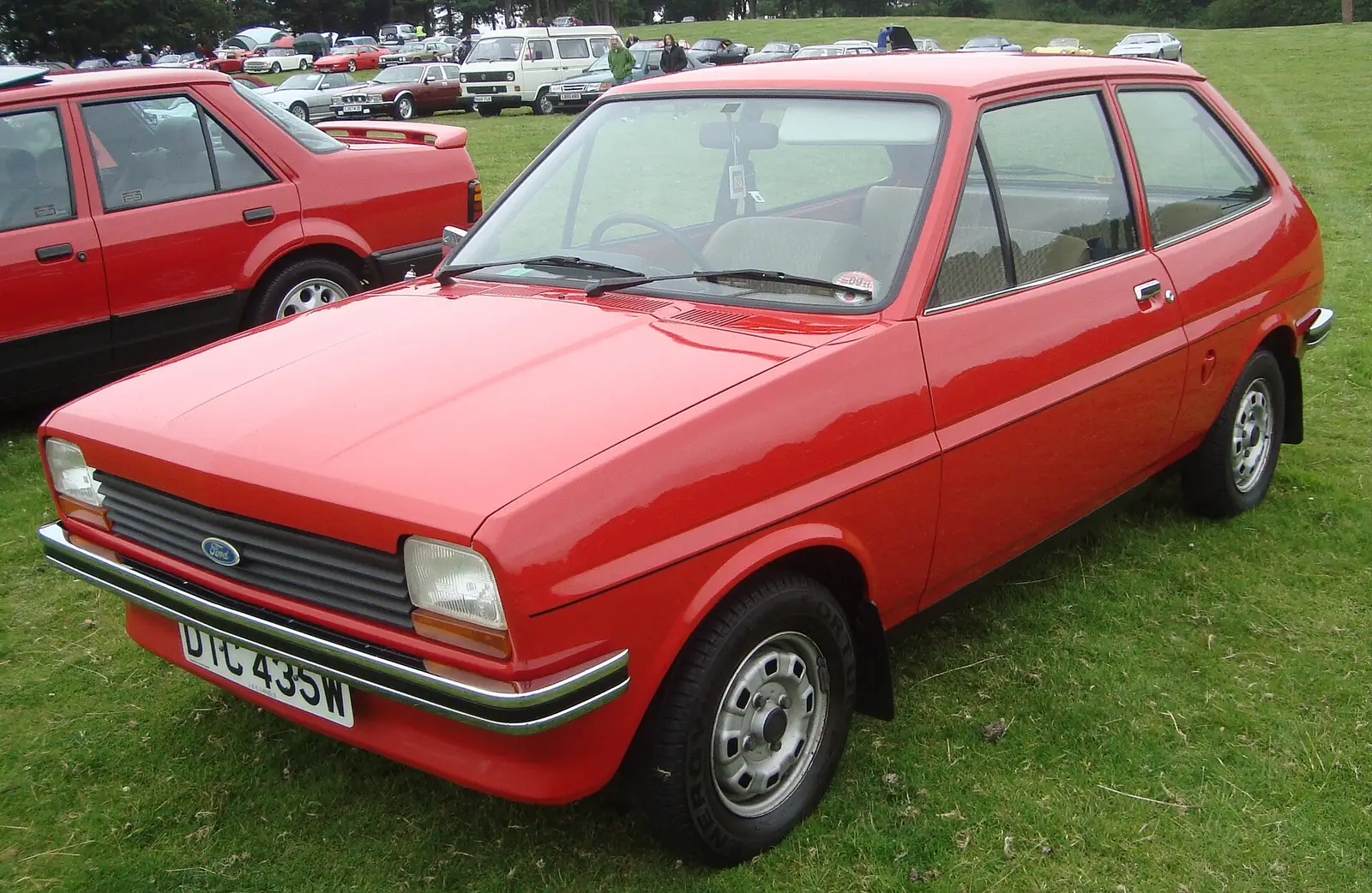 Red 1980 Ford Fiesta L three-door hatchback photographed from the front three-quarter angle at a car show