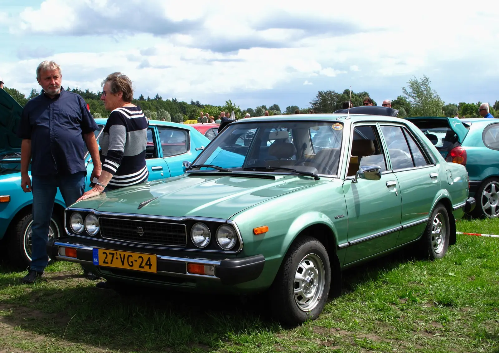 Green first-generation Honda Accord photographed from the front three-quarter angle outdoors