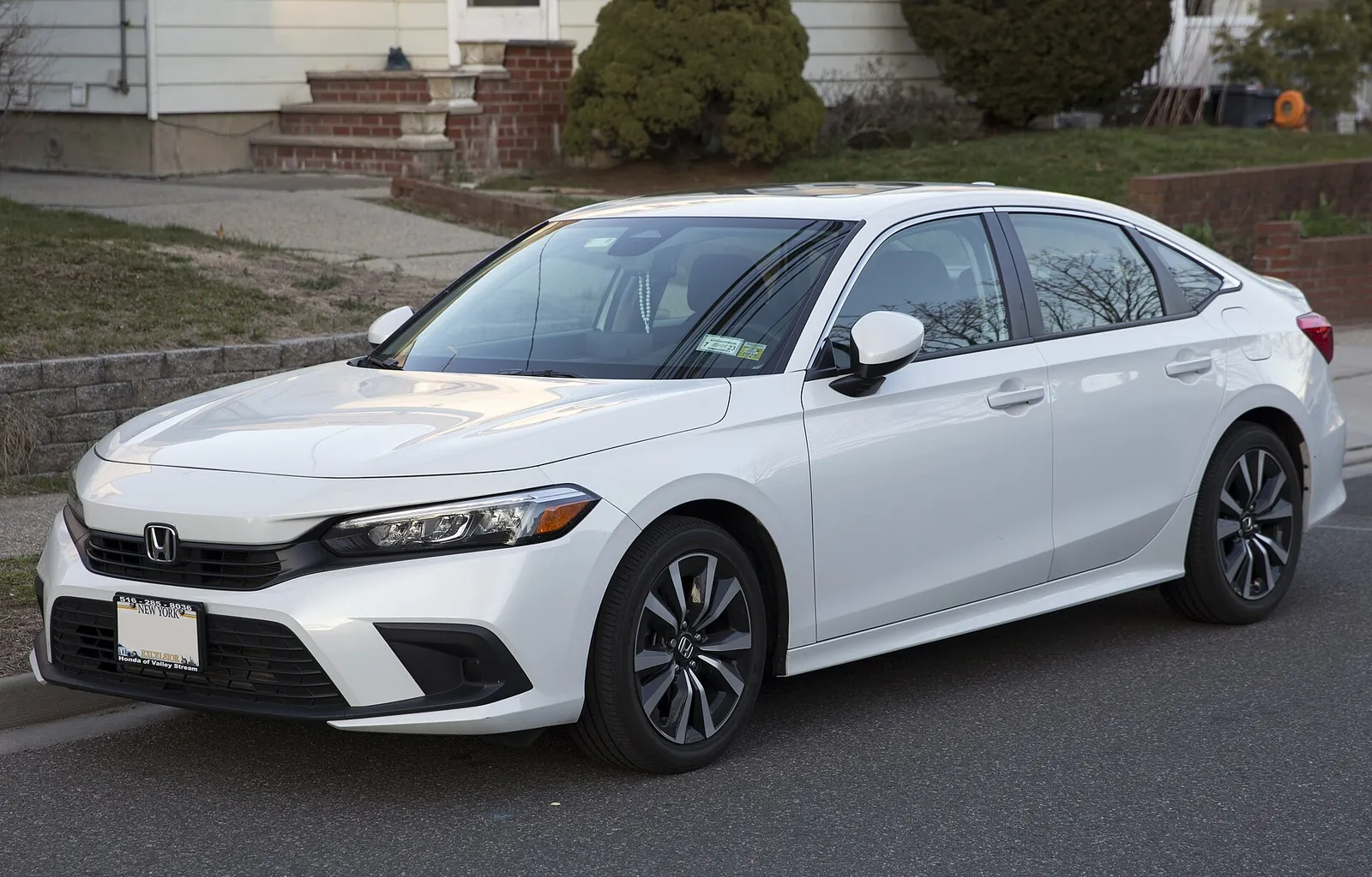 White 2022 Honda Civic Sedan EX photographed from the front three-quarter angle
