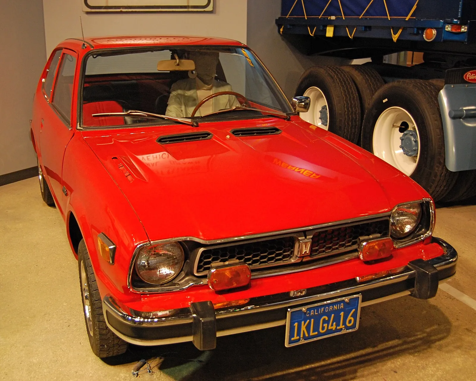 Red first-generation Honda Civic two-door photographed from the front three-quarter angle
