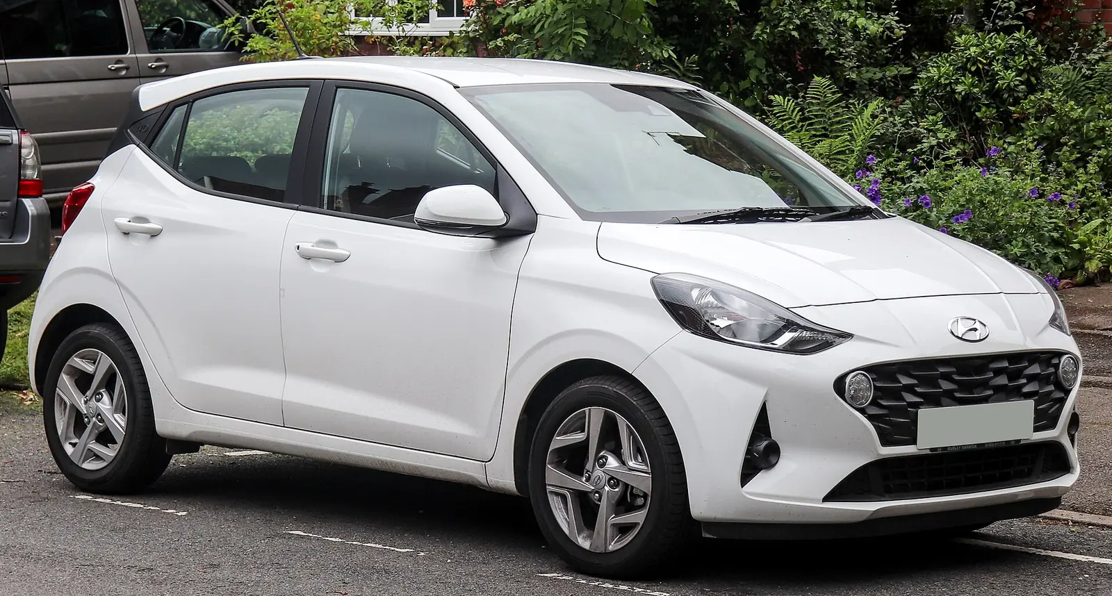 White third-generation Hyundai i10 five-door hatchback photographed from the front three-quarter angle
