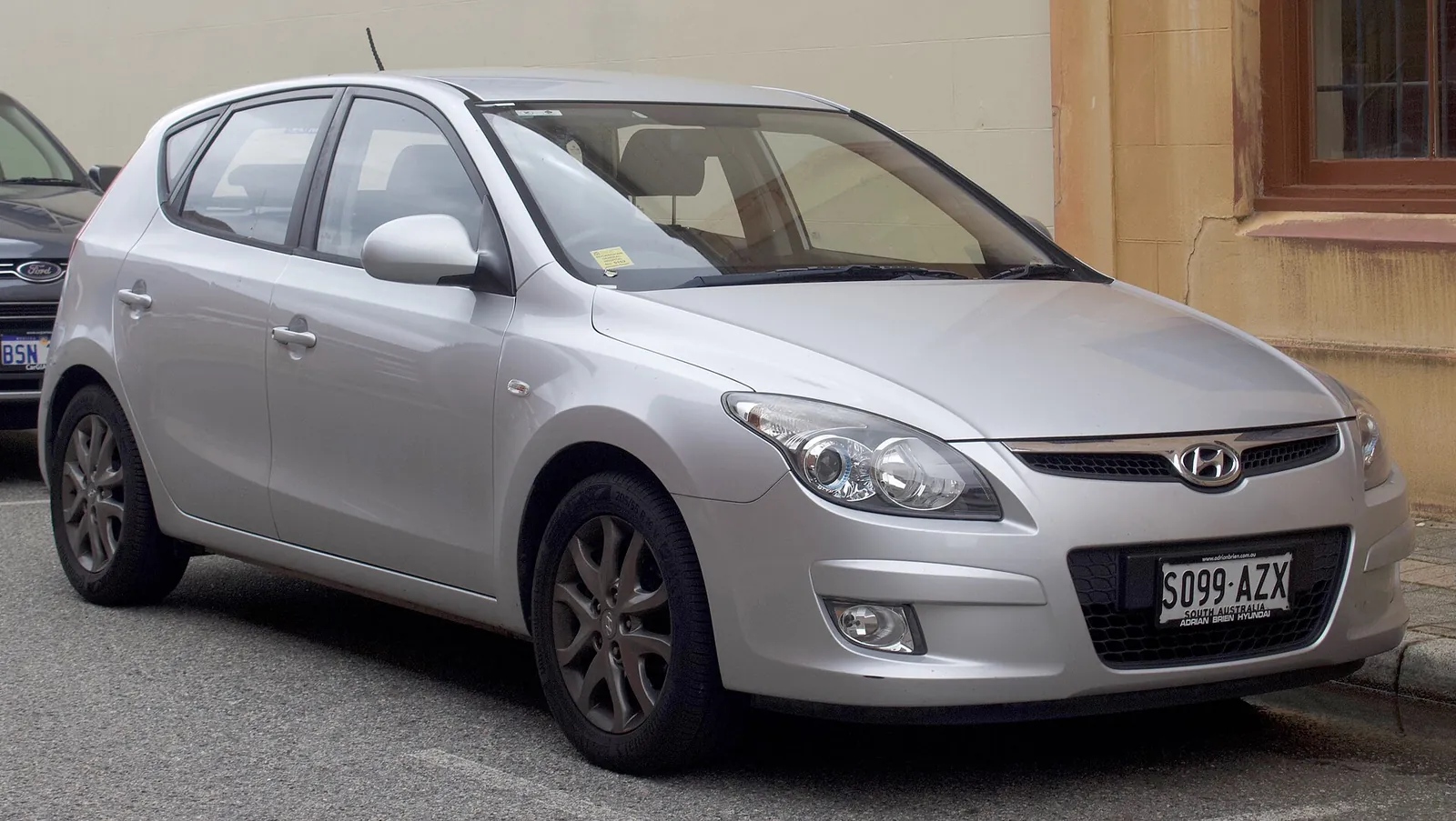 Silver first-generation Hyundai i30 five-door hatchback photographed from the front three-quarter angle