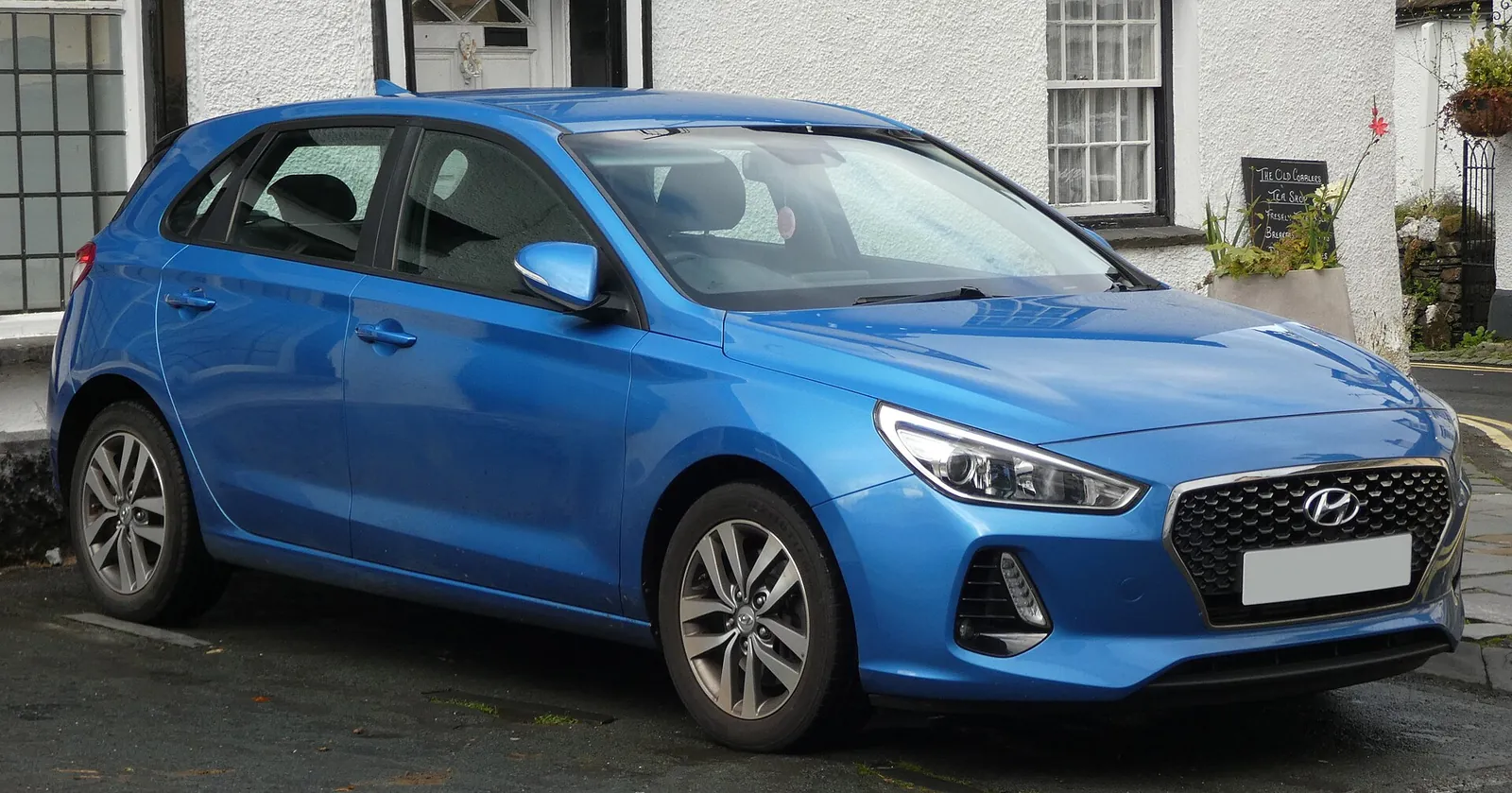 Blue third-generation Hyundai i30 five-door hatchback photographed from the front three-quarter angle