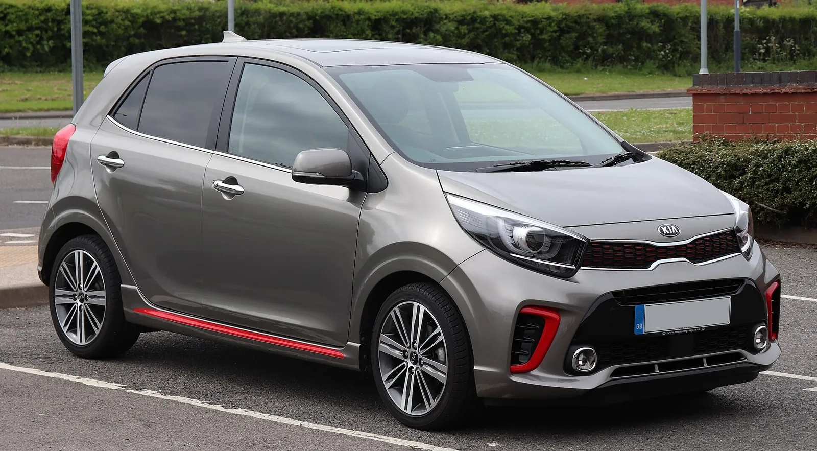 Grey third-generation Kia Picanto GT-Line hatchback with red trim accents, photographed from the front three-quarter angle