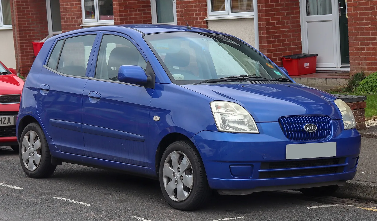 Blue first-generation Kia Picanto five-door hatchback photographed from the front three-quarter angle
