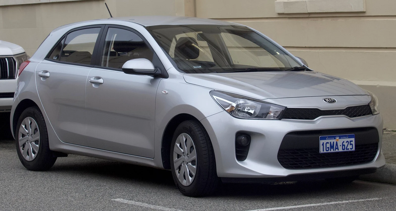 Silver fourth-generation Kia Rio five-door hatchback photographed from the front three-quarter angle