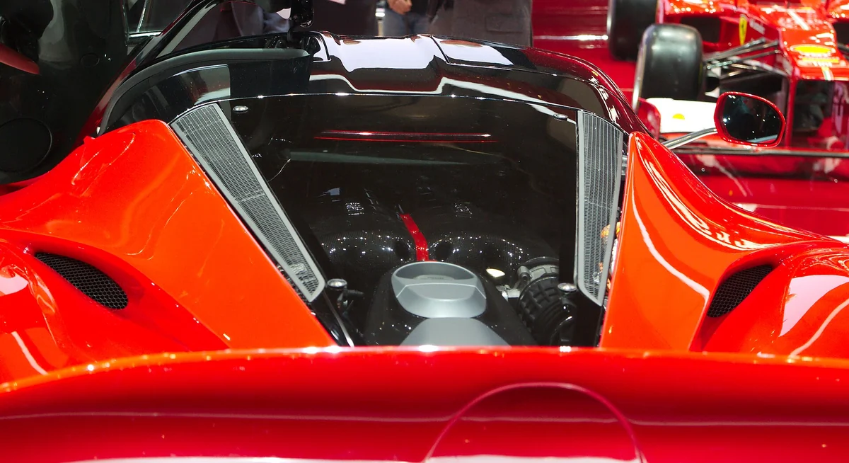 LaFerrari engine bay showing the 6.3-litre V12 and HY-KERS hybrid hardware at the 2013 Geneva Motor Show