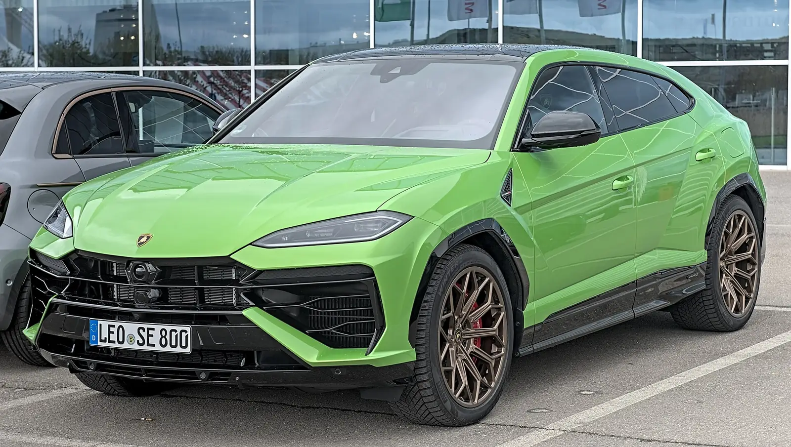Green Lamborghini Urus SE photographed from the front three-quarter angle, showing the SUV's angular Lamborghini-styled front end