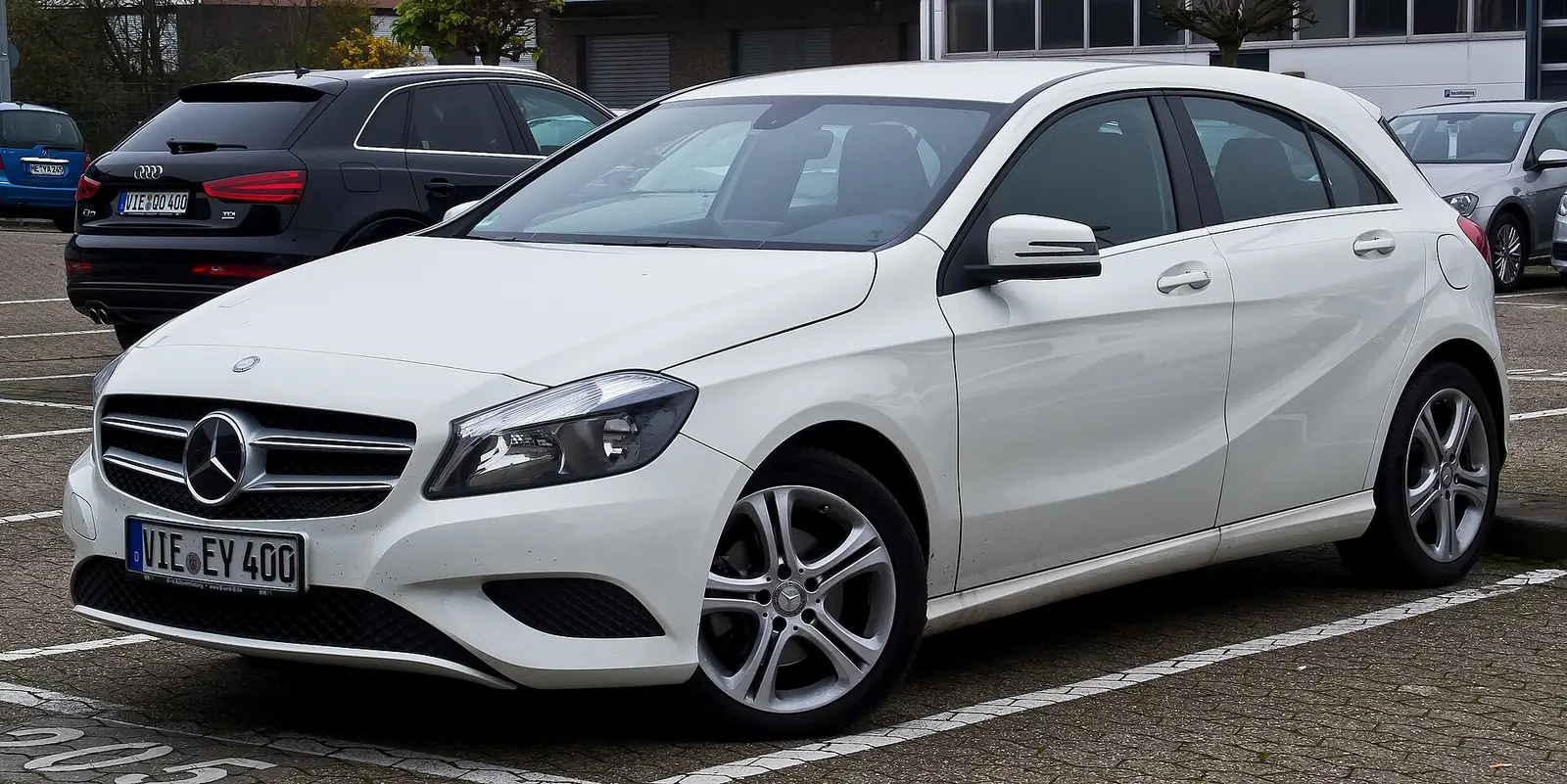 White third-generation Mercedes-Benz A-Class hatchback photographed from the front three-quarter angle in a car park