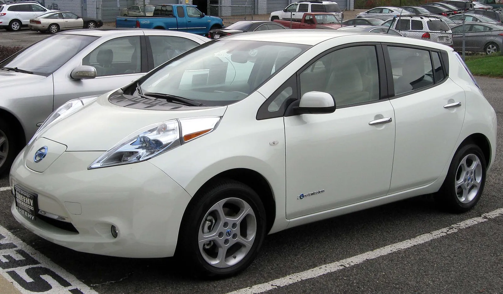 White first-generation Nissan Leaf hatchback photographed from the front three-quarter angle