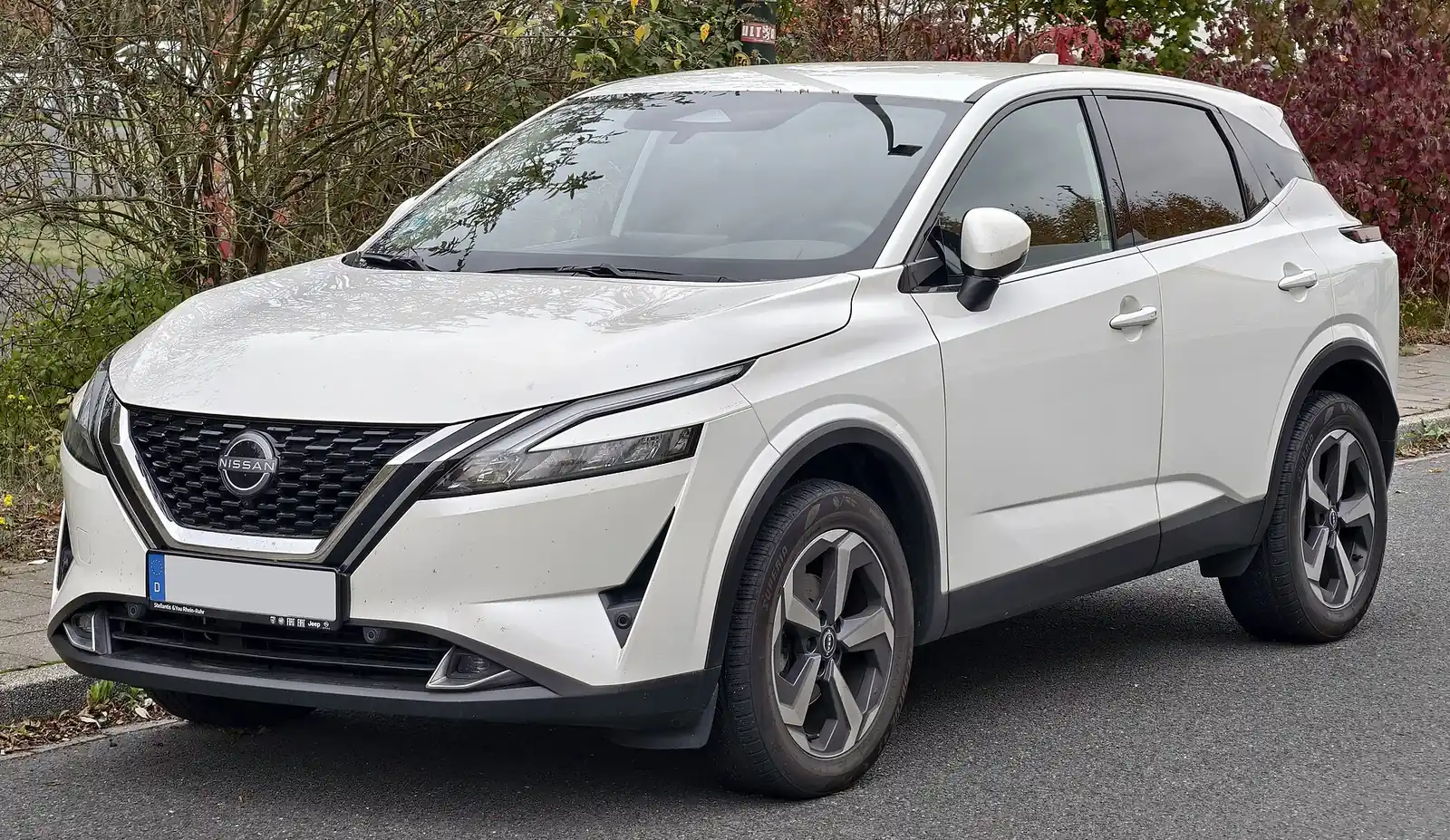 White third-generation Nissan Qashqai photographed from the front three-quarter angle, showing its sharper, more angular styling