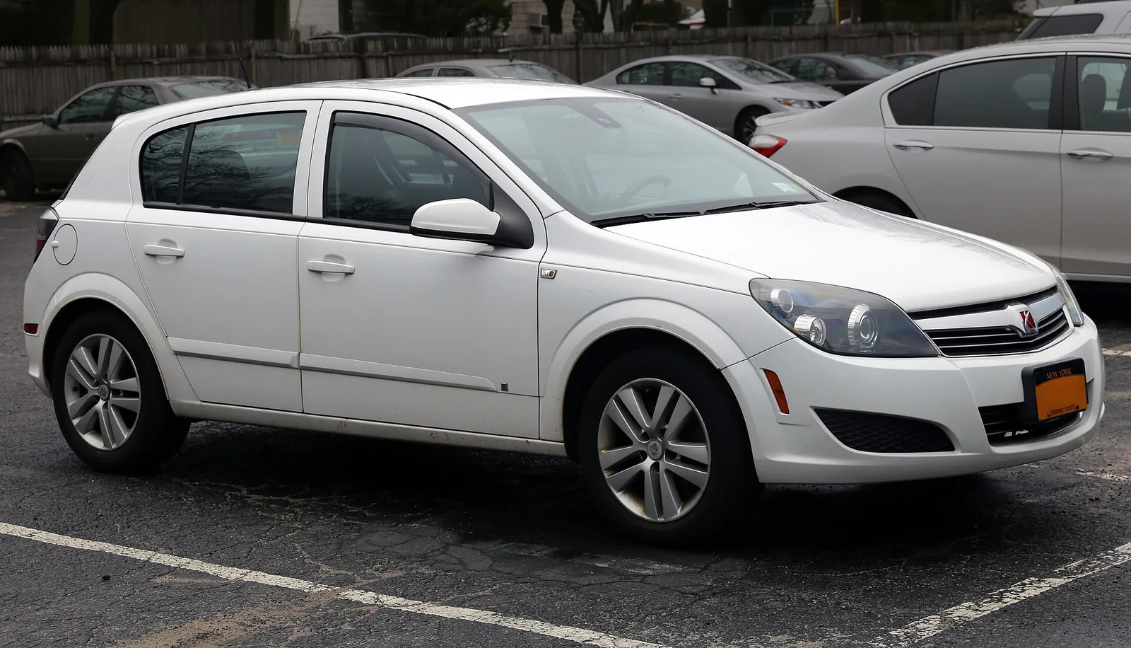 White Saturn Astra five-door hatchback, the North American badge of the Opel Astra H, photographed from the front three-quarter angle